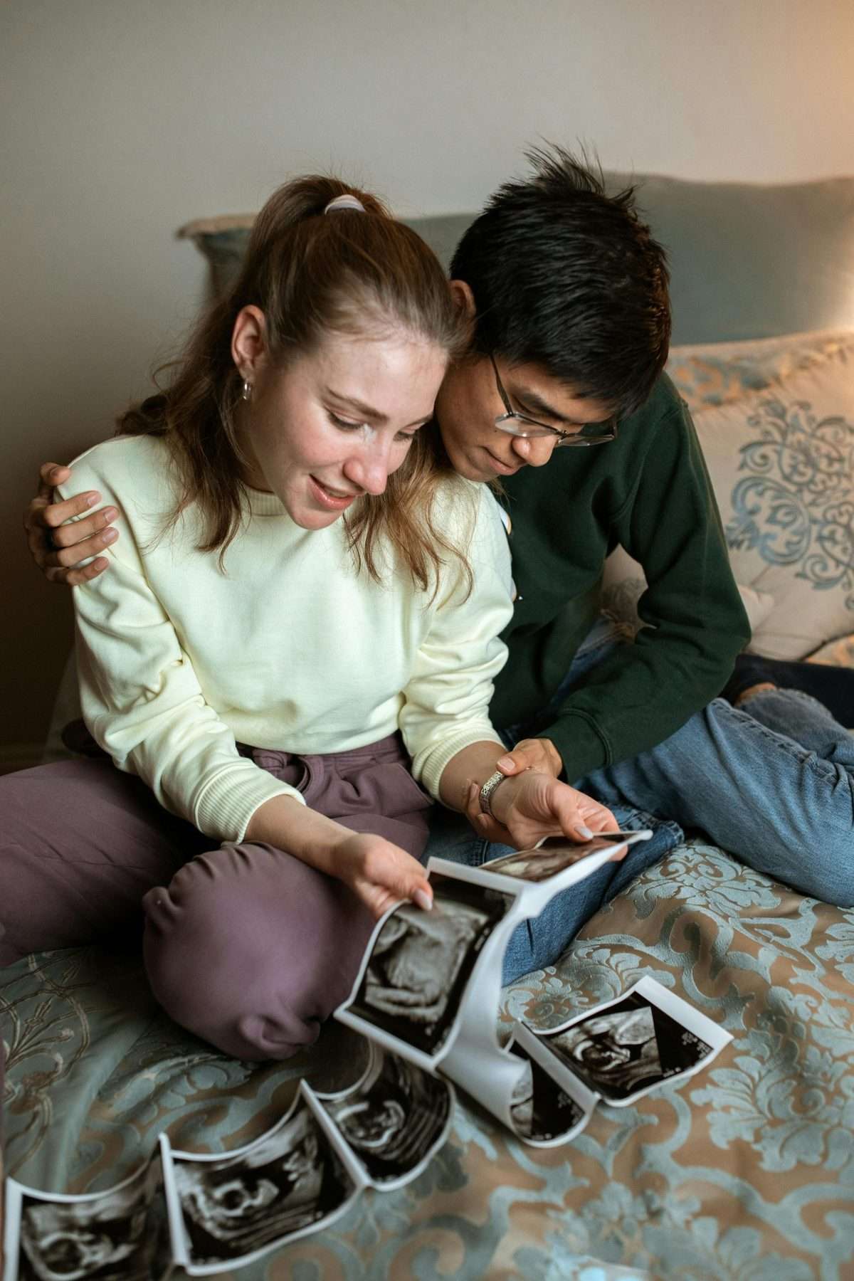 A couple reviewing ultrasound photos at home