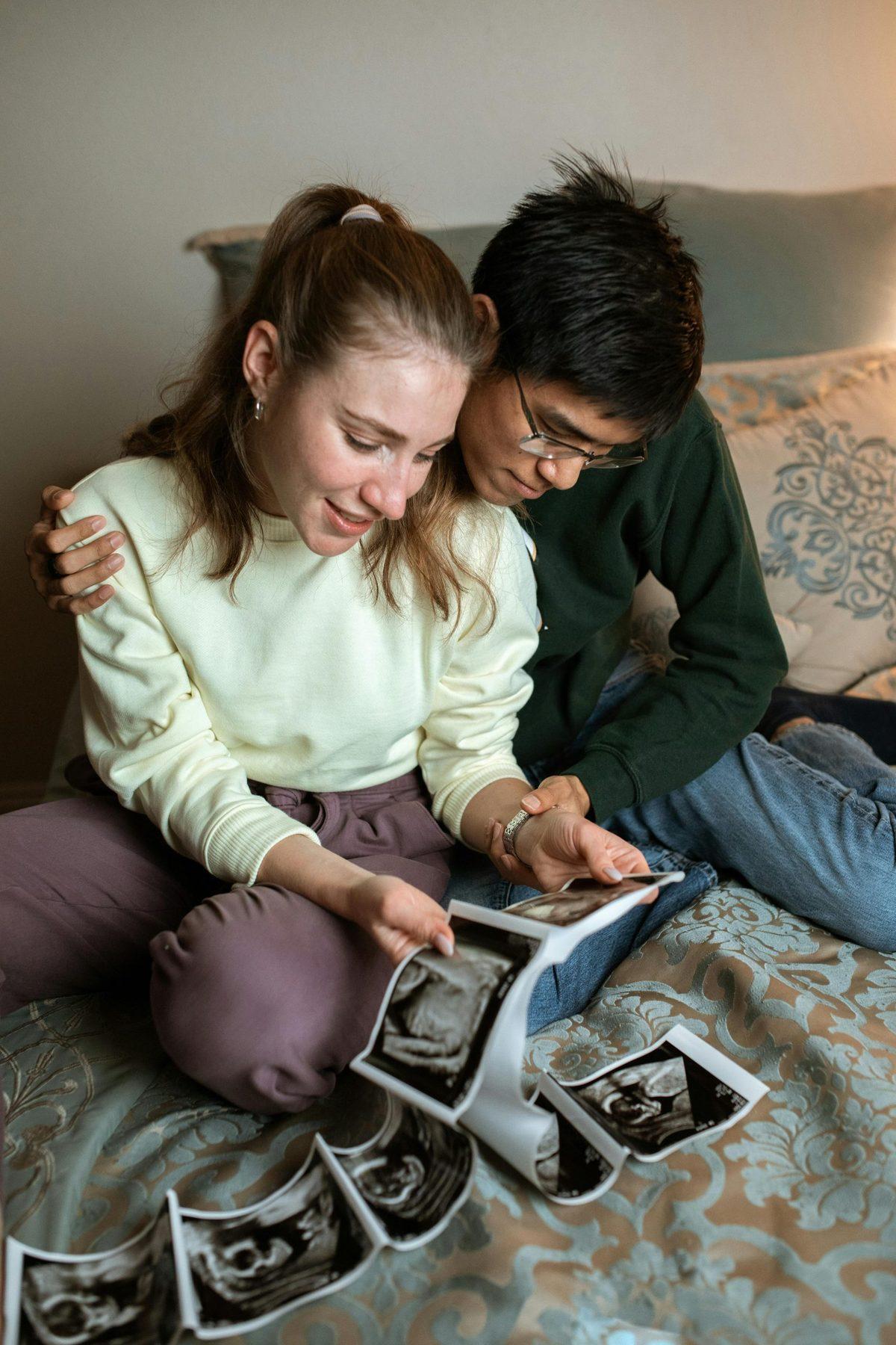 A couple looking at ultrasound photos together