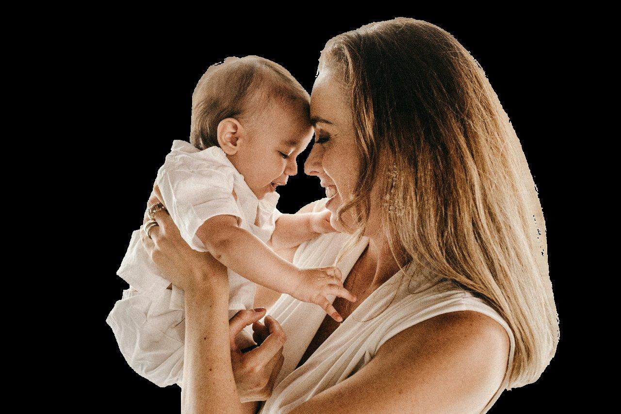 A mother holding her baby close